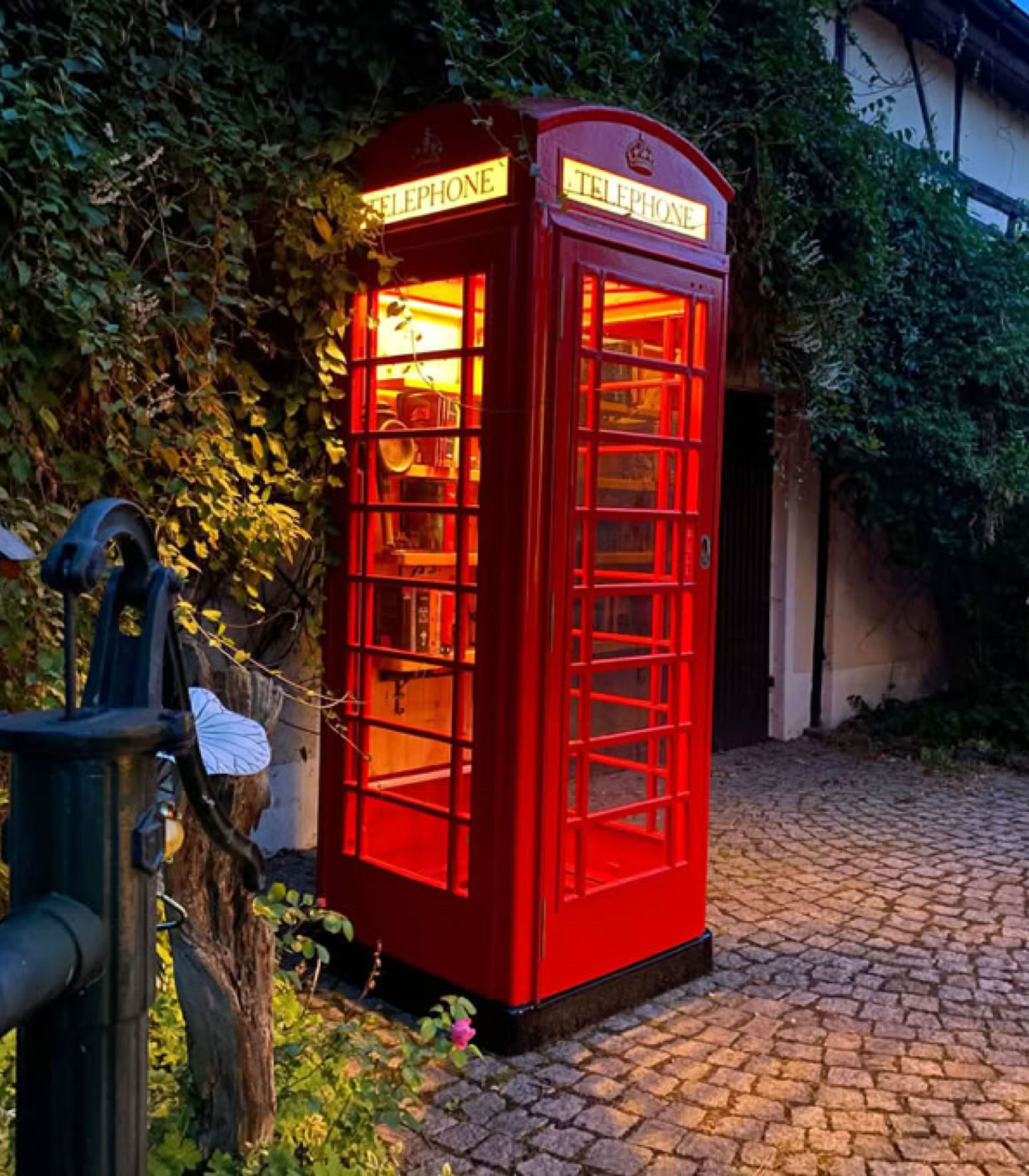 Red K6 telephone box as decoration in the garden
