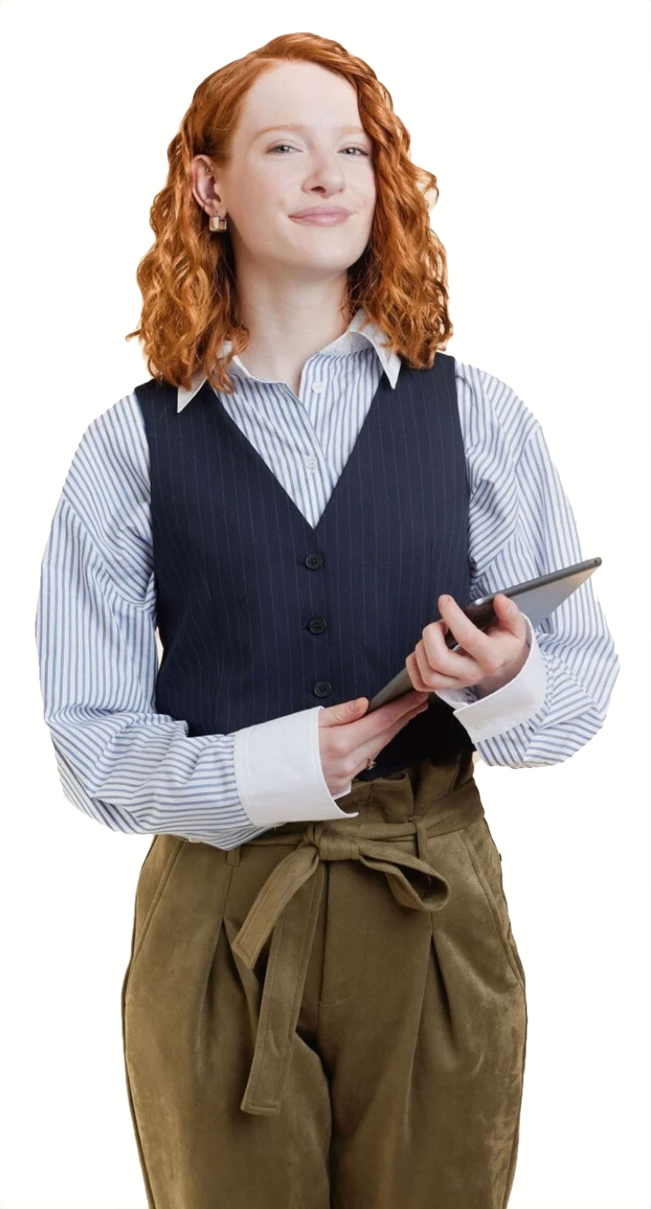 A person with red hair wearing a blue shirt, dark vest, and brown pants, holding a tablet.