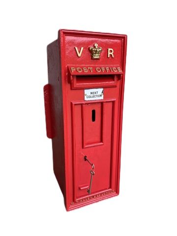 A red, vintage-style post box with "V R" and a crown emblem at the top, set against a concrete background.